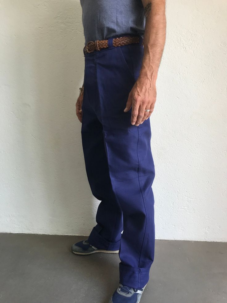 "French blue work trousers - Macober Made in France 1970s High waist pants in indigo blue sanforized cotton . Straight cut with crease. 5 button closure. Bakelite buttons. All originals. 2 side pockets, 1 buttoned back pocket. 5 belt loops. In perfet condition. New item. Deadstock With original cardbord label . Never washed. Label size: 42/10 The model usually wears a size M (40/42) and measurs 175cm - 68,8,\" Measurements (flat): Waist: 40cm - 15,7\" Hips: 57cm - 22,4\" Crotch: 34cm - 12,5\" fr Full-length Indigo Cotton Pants, Indigo Full-length Cotton Pants, Full Length Indigo Cotton Pants, Full Length Cotton Pants In Indigo, Indigo Full Length Cotton Pants, Navy Cotton Tapered Leg Work Pants, Navy Cotton Work Pants, Navy Cotton Work Trousers, Blue Cotton Work Pants With Pockets