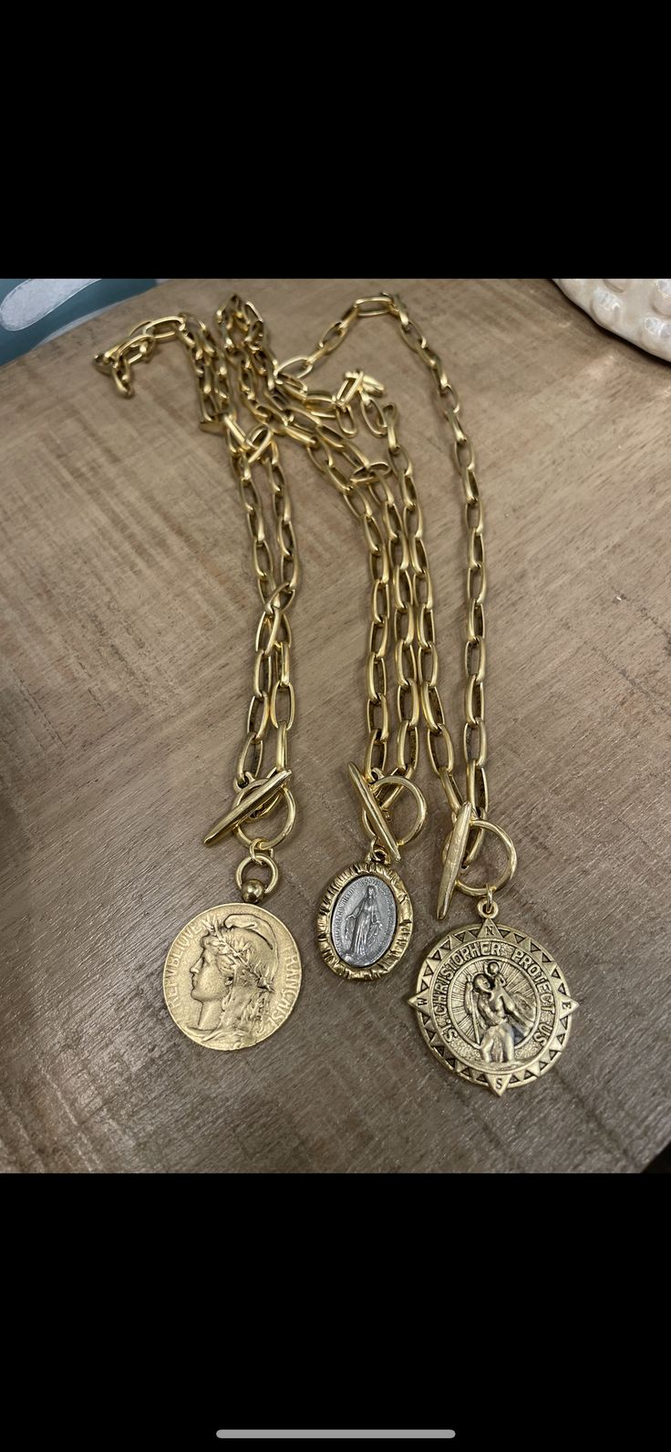 Beautiful antique gold replica coin necklaces with antique gold toggle chain. Choice of French Marianne lady, two tone oval Mary medal or St. Christopher coin. Please leave choice of coin im note section when checking out. Length of chain is 17” with toggle and coin adding approximately 1” to length. Shipping is within 5 days after checking out. Handmade in Franklin, Tennessee. Franklin Tennessee, St Christopher, Gold Cross, Coin Necklace, Crystal Pendant, Antique Gold, Two Tone, Coin, Gold Necklace