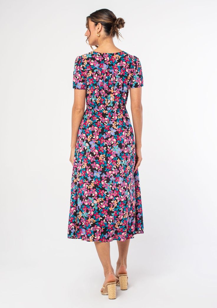 A lightweight bohemian midi dress in a bright multicolor floral print. A bright, multicolor floral print adds an eye-catching touch to this classic mid-length dress, featuring a flattering surplice v-neckline, short sleeves, and a relaxed fit. The drawstring waist can be tied tight for a waist-defining look, or wear it loose for a relaxed & comfortable fit. Floral print Relaxed fit Short sleeve Mid-length Surplice v-neckline Hook & eye closure Adjustable drawstring waist Women's bohemian dress M Multicolor V-neck Floral Dress With Vibrant Print, Spring Floral V-neck Dress With Vibrant Print, Multicolor Floral Print V-neck Dress, Multicolor Floral V-neck Dress With Vibrant Print, Spring Multicolor Midi Dress With Surplice Neckline, Multicolor Surplice Neckline Midi Dress For Spring, Spring V-neck Multicolor Print Maxi Dress, Multicolor Floral Print Midi Dress, Spring Multicolor Print V-neck Maxi Dress