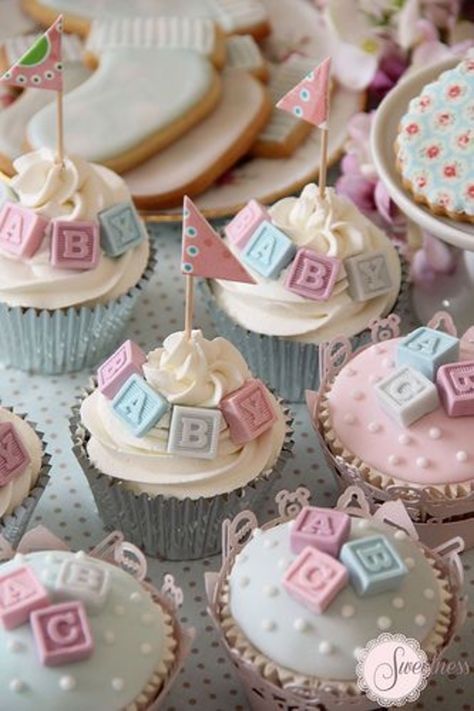 cupcakes decorated with baby blocks and flags