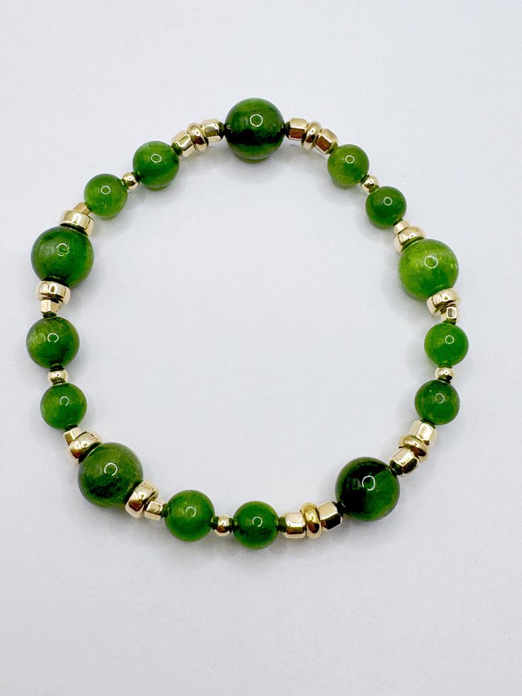 Tsavorite crystals in 6.5mm and 9mm bead sizes combined to give a very lively green, prosperous and elegant bracelet. Tsavorite is a rare green garnet with Chromium mineral that contributes to the green color.  The crystal comes about by the metomorphic folding and unfolding  movements of the rock therefore inclusions in the crystal is a characteristic of the lively tsavorite.  The mineral rock is found in Kenya, Tanzania and Antartic region. The rare healing energies of this crystal is gentle y Elegant Jade Jewelry With Spacer Beads, Green Polished Round Beads Jewelry, Elegant Green 8mm Beads Jewelry, Elegant Green Jewelry With 8mm Beads, Green Spiritual Rondelle Beaded Bracelets, Green Rondelle Beaded Spiritual Bracelets, Green Polished Aventurine Beads Jewelry, Green Gemstone Beads Jewelry For Meditation, Green Aventurine Jewelry With Polished Beads