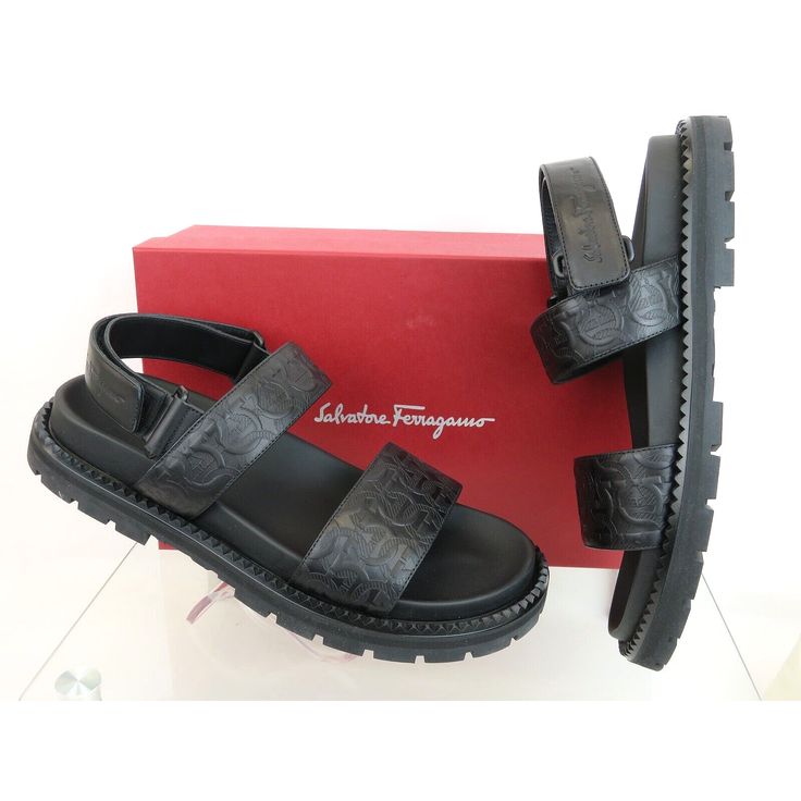 Notorius Black Leather Gancini Embossed Strap Sandals By Salvatore Ferragamo Made In Italy 100% Authentic, Guaranteed! Size: Us 10 M Color: Nero (Print On The Box) Gancini Pattern Embossed Leather Upper Logo Velcro Back Strap Leather Lined Logo Stamped Molded Insole Chunky Logo Rubber Sole Original Price: $795 Note !!! These Shoes Came From Ferragamo's Brand Name Store In Its Original Box. They Are New But They Are In-Store Item And It’s Possible That Somebody Tried Them On Inside The Store. Thi Luxury Sandals With Leather Footbed And Ankle Strap, Black Calf Leather Sandals With Ankle Strap, Luxury Ankle Strap Sandals With Leather Footbed, Luxury Calf Leather Sandals With Textured Sole, Designer Calf Leather Sandals With Rubber Sole, Black Calf Leather Sandals With Leather Footbed, Designer Sandals With Rubber Sole In Calf Leather, Black Flat Heel Calf Leather Sandals, Luxury Black Sandals With Rubber Sole