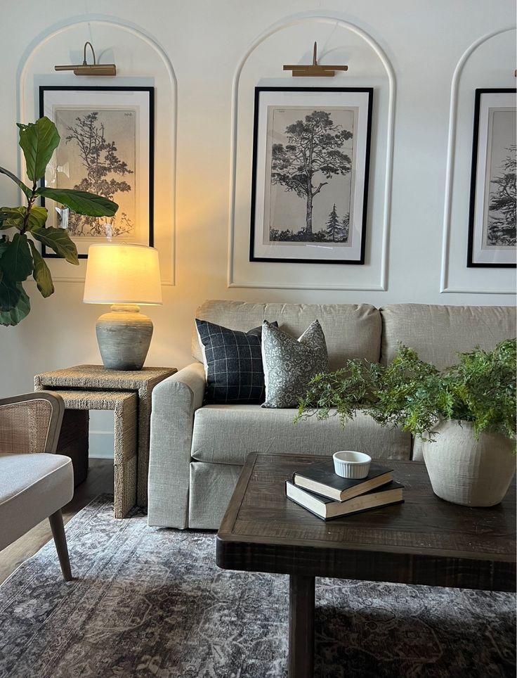 a living room filled with furniture and pictures on the wall above it's coffee table