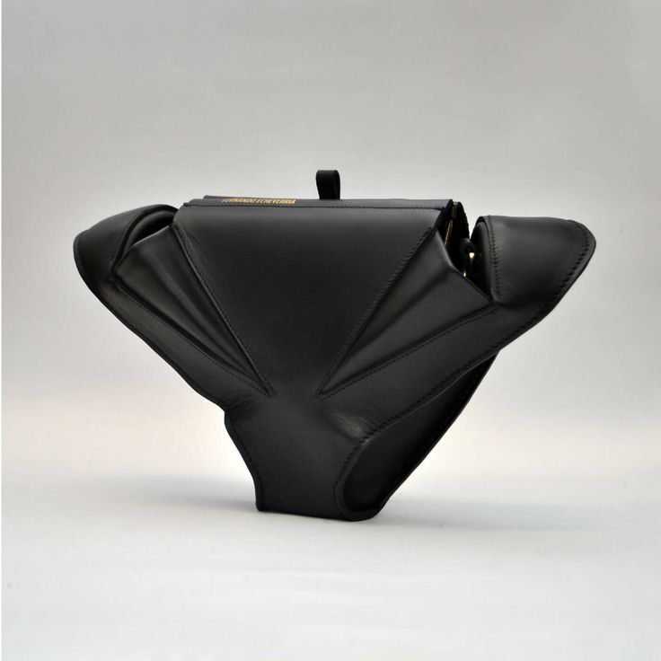 Made from genuine natural Toscan leather without chrome. A unique shape inspired by the animal world and organic lines. It can be held in the hand for a more elegant style or used with a detachable leather strap.The bag has one small inner pocket and one outer pocket with a classic metal lock. Not only a bag, but also a sculpture to be wornThe dimensions of the envelope are 17x 15 x 10 cmFor carrying in the hand or over the shoulder thanks to a removable leather strip with a length of 120 cm.Han Black Saddle Bag With Detachable Top Handle, Black Rectangular Saddle Bag For Evening, Black Rectangular Evening Saddle Bag, Formal Black Saddle Bag With Detachable Handle, Modern Black Leather Saddle Bag, Evening Saddle Bag Tote With Detachable Strap, Evening Saddle Bag With Removable Pouch, Elegant Black Belt Bag For Daily Use, Leather Tote Saddle Bag For Evening