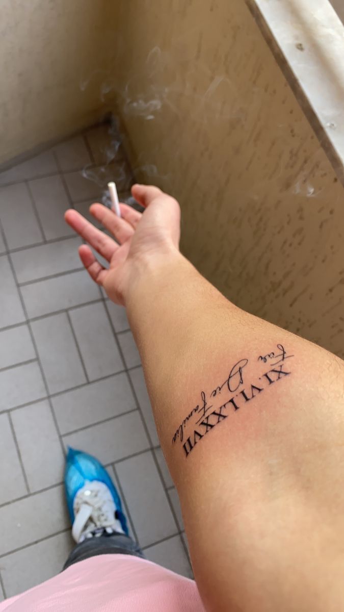 Name With Roman Numeral Tattoo, Placement For Name Tattoos, Name And Roman Numeral Tattoo, Birthday Tatoos Ideas, Cursive Roman Numeral Tattoo, Tattoo Roman Numeral, Roman Numeral Tattoo With Name, Sons Name Tattoos, Forearm Name Tattoos