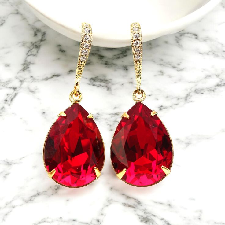 Brighten up your mood instantly with these elegant and sparkling  Red Crystal Earrings in Gold plated finish! The one-of-a-kind brilliance and intense luminosity are a result of alternating large and small facets. Perfect Valentine's Day and Christmas gift! Earrings made with: - the gorgeous and genuine 18x13mm Siam  teardrop pear shaped fancy stones, set in gold plated settings - Hypoallergenic and tarnish resistant 16k gold plated rhinestone ear hooks - these are approx 1 1/2" from top of the Elegant Red Bridal Earrings For Party, Teardrop Earrings For Valentine's Day Party, Red Drop Bridal Earrings As Gift, Ruby Drop Earrings For Party, Red Drop Earrings For Bridal Gift, Ruby Drop Earrings For Bridal Party, Ruby Bridal Earrings For Party, Red Teardrop Earrings For Evening, Red Drop Crystal Earrings For Anniversary