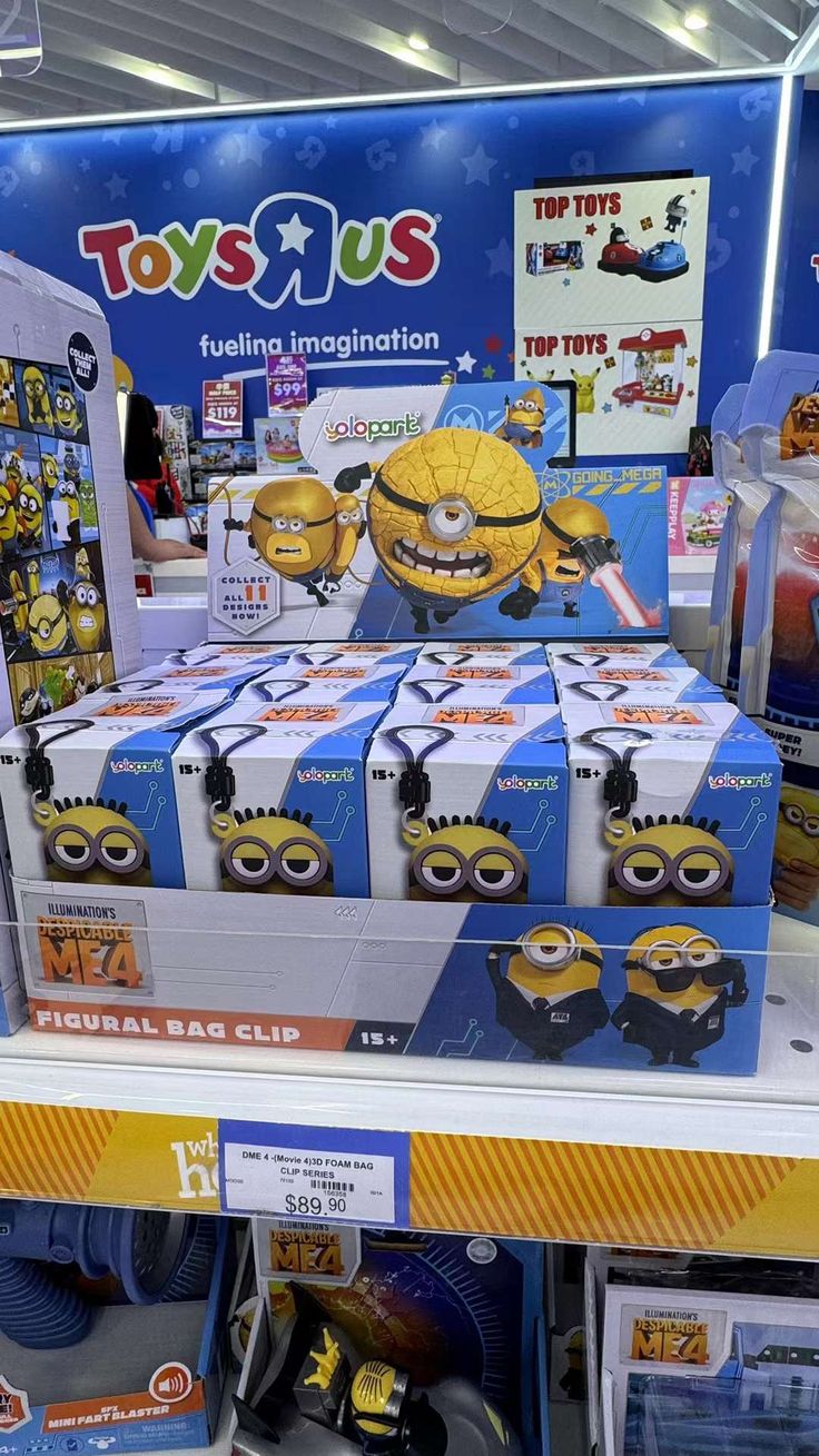 toys r us display in store with minion figures on it's shelf and other items