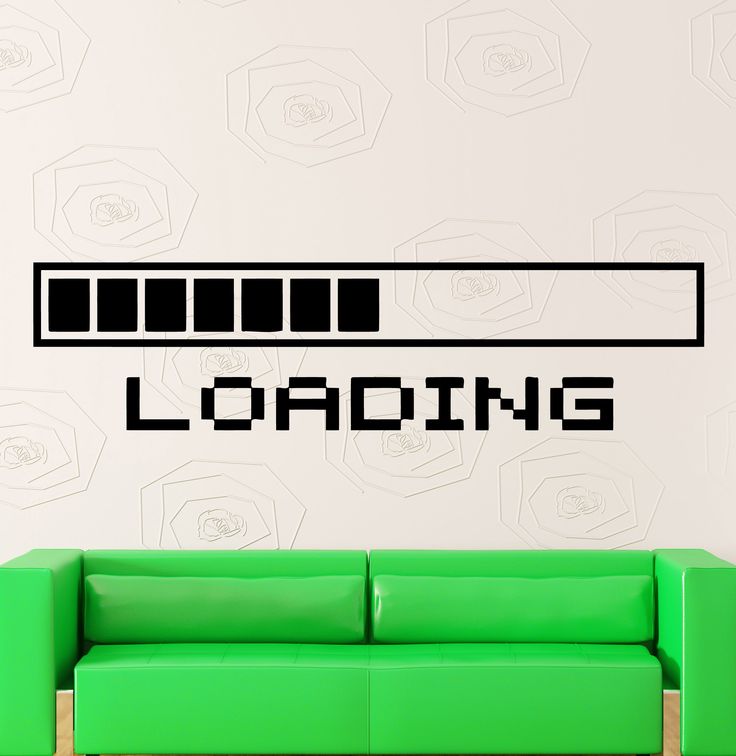 a green couch sitting in front of a wall with the word loading on it's side