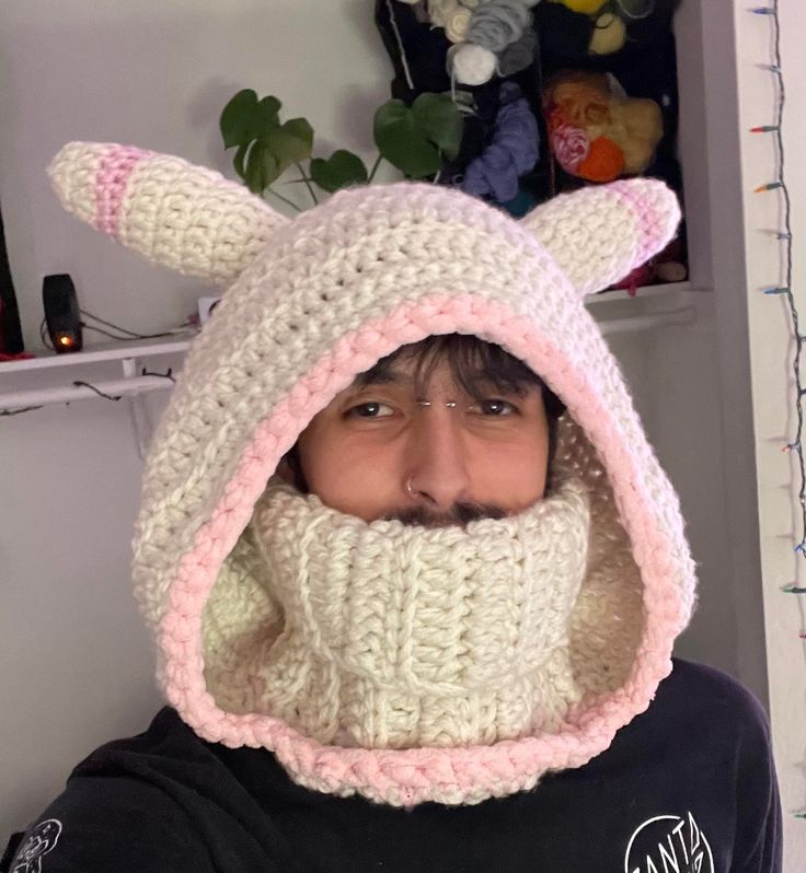 a person wearing a knitted animal hat and scarf