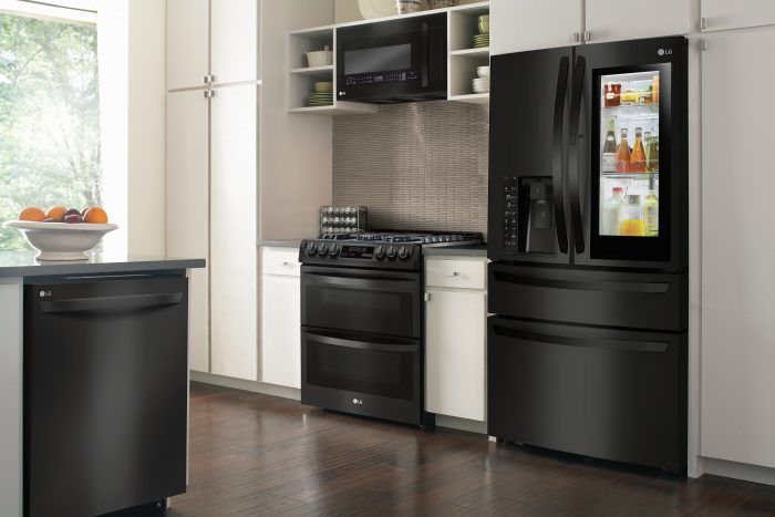 a kitchen with black appliances and white cabinets