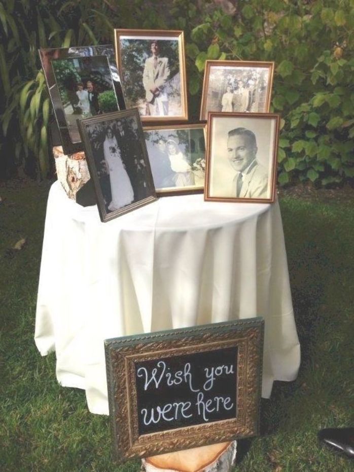 a table topped with pictures and framed photos next to a sign that says wish you were here