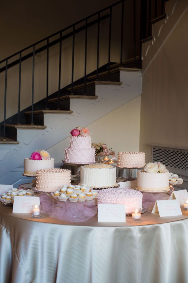 a table topped with lots of cakes and candles