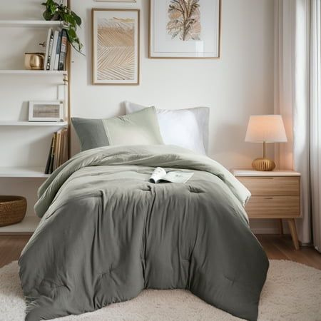 a bedroom with a bed, nightstands and pictures hanging on the wall above it