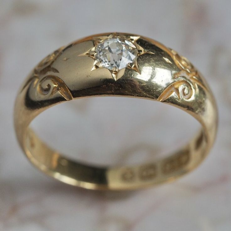 a gold ring with a diamond on it