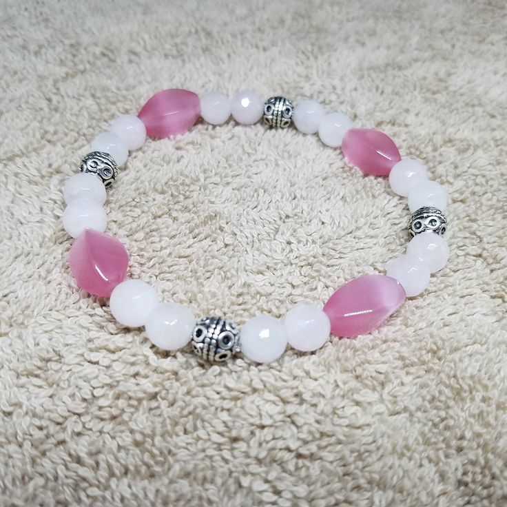 Rose Quartz Pink Cat's Eye Stretch Bracelet This bracelet was made with beautiful 8 mm rose quartz beads and pink cat's eye beads. This is a beautiful bracelet that will promote unconditional love. This bracelet is also easy to put on and take off. Beautiful on it's own or layer with other bracelets. So pretty, you will want to wear it everyday! * The fair and lovely Rose Quartz, with its gentle pink essence, is a stone of the heart, a Crystal of Unconditional Love. It carries a soft feminine en Adjustable Pink Charm Bracelet With 8mm Beads, Pink Stretch Bracelet With 8mm Beads For Friendship, Pink 8mm Beads Stretch Bracelet For Friendship, Pink Friendship Bracelet With 8mm Beads, Pink Stretch Bracelet With Faceted Beads For Gift, Adjustable Pink Rosary Bracelet With Faceted Beads, Pink Rose Quartz Bracelets For Valentine's Day, Pink Rose Quartz Bracelet For Friendship, Pink Rose Quartz Bracelet As Gift