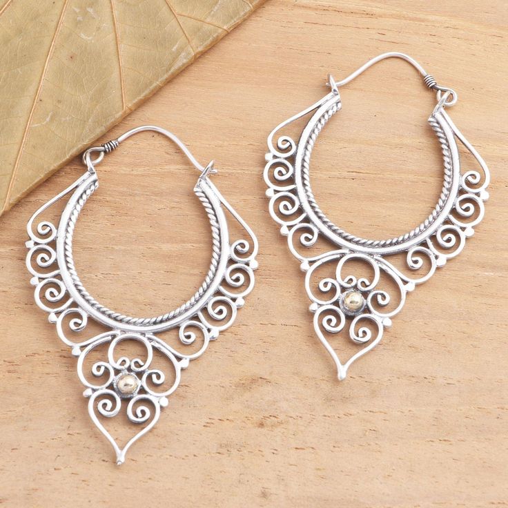 Dewi Putera of Bali presents these generously sized sterling silver hoops crafted using a combination of handwork and casting. Intricate spiral and roping motifs--characteristic of Balinese jewelry design--are complemented by gold-plated accents making them versatile enough to pair with other jewelry. Spiral Sterling Silver Jewelry With Oxidized Finish, Spiral Silver Hoop Earrings As Gift, Spiral Sterling Silver Hoop Earrings, Silver Spiral Hoop Earrings As Gift, Silver Spiral Handmade Hoop Earrings, Handmade Spiral Silver Hoop Earrings, Silver Spiral Hoop Earrings Nickel-free, Spiritual Sterling Silver Hoop Earrings, Nickel-free Silver Spiral Hoop Earrings