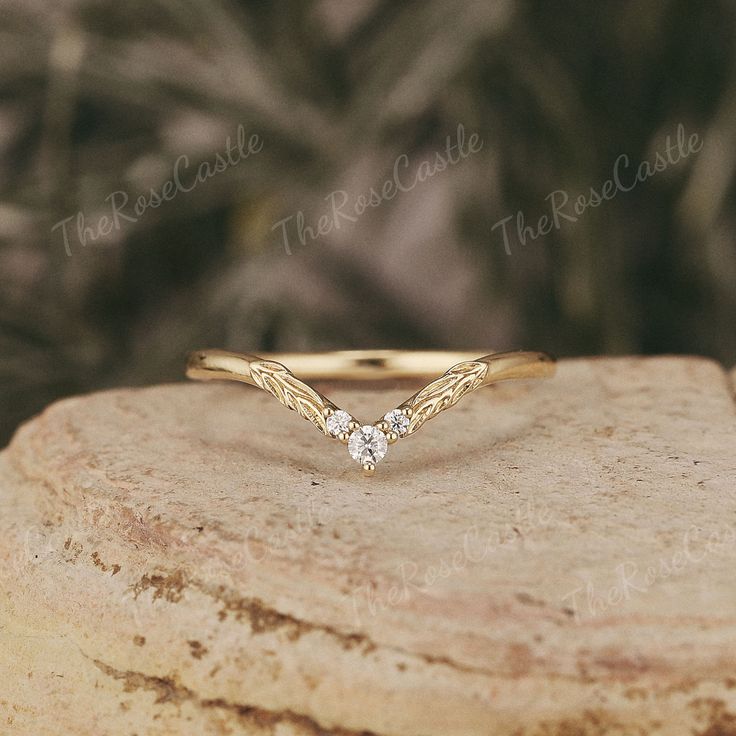 a diamond ring sitting on top of a piece of rock next to a tree branch