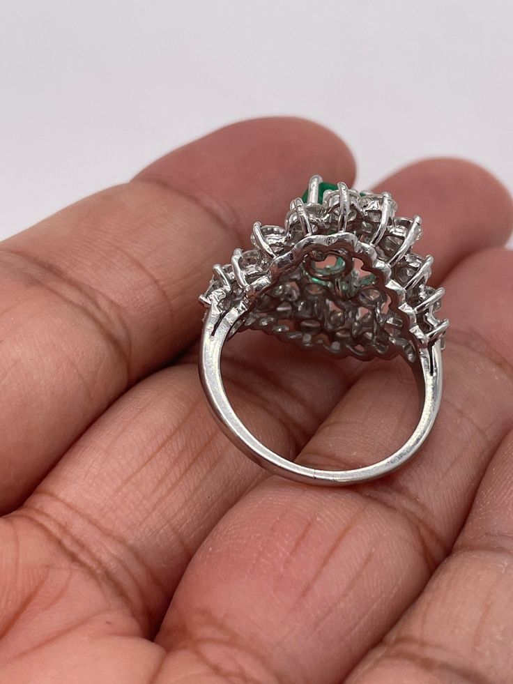 Stunningly gorgeous, Emerald & Diamond Ring set in Platinum. Handmade. Beautiful quality piece of jewelry. Approximately 2.20 ct. in Diamonds, Emerald is nice color & measures 1.15 ct. Diameter of ring is 19mm, size 6 but can be sized. Circa 1950's White Gold Emerald Ring With Brilliant Cut Cluster, White Gold Cluster Emerald Ring With Brilliant Cut, Green Emerald Cluster Ring In Platinum, Cluster Green Emerald Ring In Platinum, Green Platinum Emerald Ring With Cluster Shape, Platinum Cluster Emerald Ring, Pear-shaped Brilliant Cut Emerald Ring In White Gold, Fine Jewelry Pear-shaped Emerald Ring Vvs Clarity, Fine Jewelry Pear-shaped Emerald Ring With Vvs Clarity