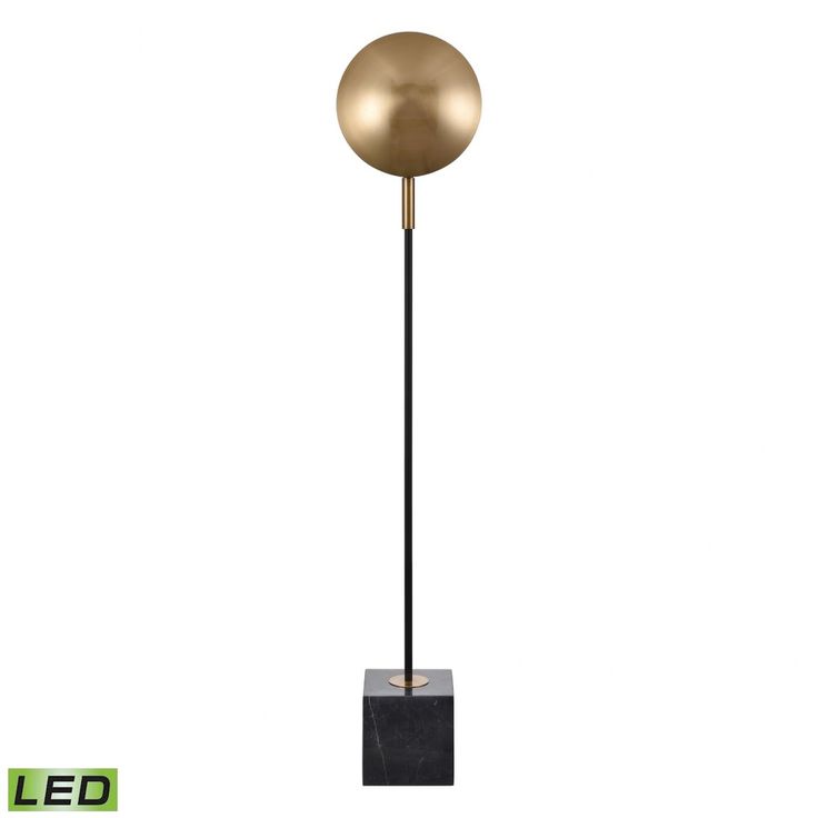 a black and gold floor lamp on a white background