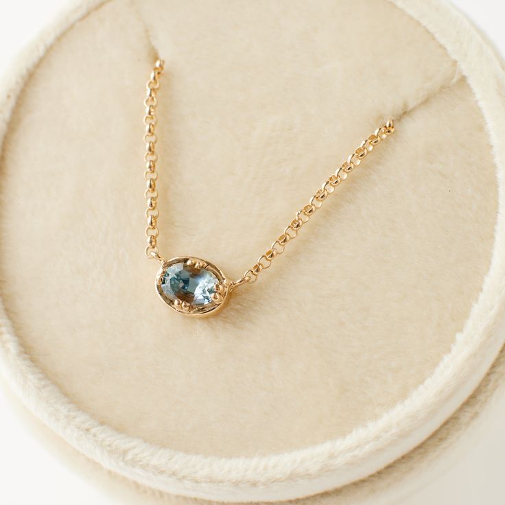 Why it's special: Introducing the Fiona Necklace, a timeless piece that effortlessly blends refined elegance with everyday wearability. At its center lies an approximately .6o carat captivating Montana sapphire, showcasing a delicate blue hue that evokes the serene beauty of a spring morning sky. Encircled by a signature golden halo—an iconic element of Porter Gulch's distinctive style, inspired by our beloved Emery setting—this necklace is a celebration of grace and modern sophistication. Perfectly crafted for those who appreciate subtle elegance, the Fiona Necklace is an exquisite embodiment of contemporary luxury. How many are available? Only two light blue Fiona necklaces are available! DETAILS: Made of 14 karat yellow gold Set with an approximately .60 carat light blue oval sapphire; Light Blue Sapphire Necklace, Classic Yellow Gold Sapphire Necklace, Elegant Sapphire Faceted Necklace, Sapphire Diamond Necklace Shane Co., Faceted Sapphire Pendant Necklace, Montana Sapphire Necklace, Diamond Band Engagement Ring, Light Blue Sapphire, Blue Stone Necklace