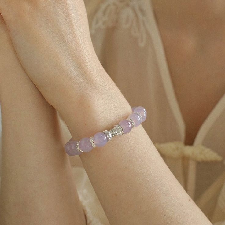 This stunning amethyst onyx bracelet features a collection of sparkling diamonds. The mesmerizing hues of amethyst onyx blend perfectly with the brilliance of diamonds to create a captivating accessory that exudes elegance and sophistication. Metal: Recycled Sterling Silver Gemstone: Cubic Zirconia,Purple Chalcedony 10mm Diameter: Small Size 130-140mm,Large Size 150-160mm Weight: 26g Elegant Crystal Gemstone Bracelet As Gift, Elegant Crystal Bracelet With Gemstone For Gift, Luxury Purple Jewelry With Round Beads, Elegant Crystal Gemstone Bracelet For Gift, Elegant Amethyst Rondelle Jewelry, Elegant Crystal Gemstone Bracelet, Silver Crystal Bracelet With Round Gemstone Beads, Cubic Zirconia Crystal Bracelet With Gemstones, Round Cubic Zirconia Crystal Bracelet With Gemstones