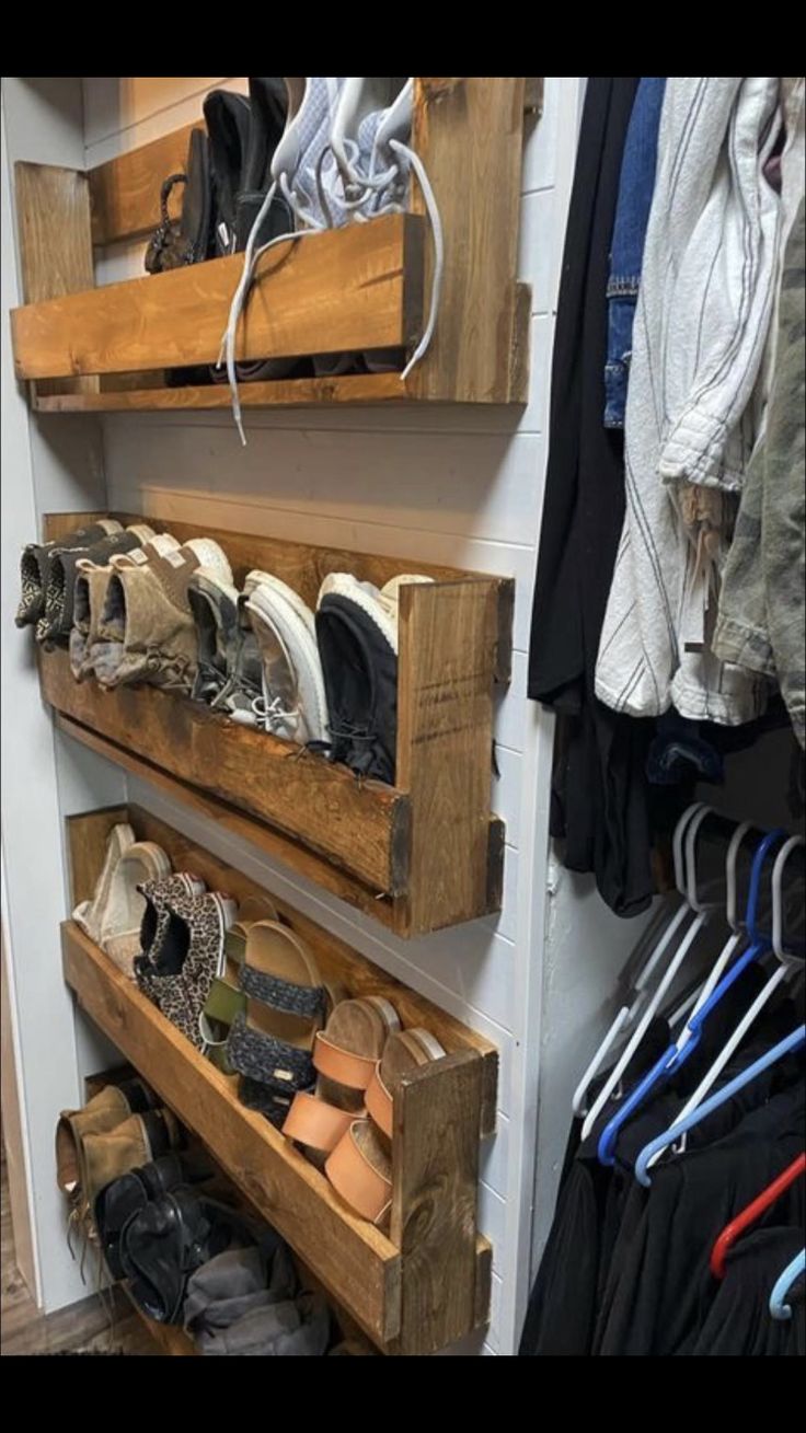 two wooden shelves filled with pairs of shoes