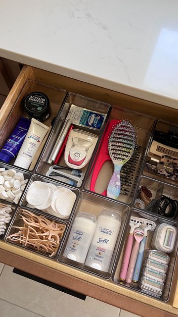 the drawers are organized with various items such as toothbrushes, shampoos and lotion