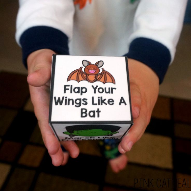 a person holding a box with a bat on it that says flap your wings like a bat