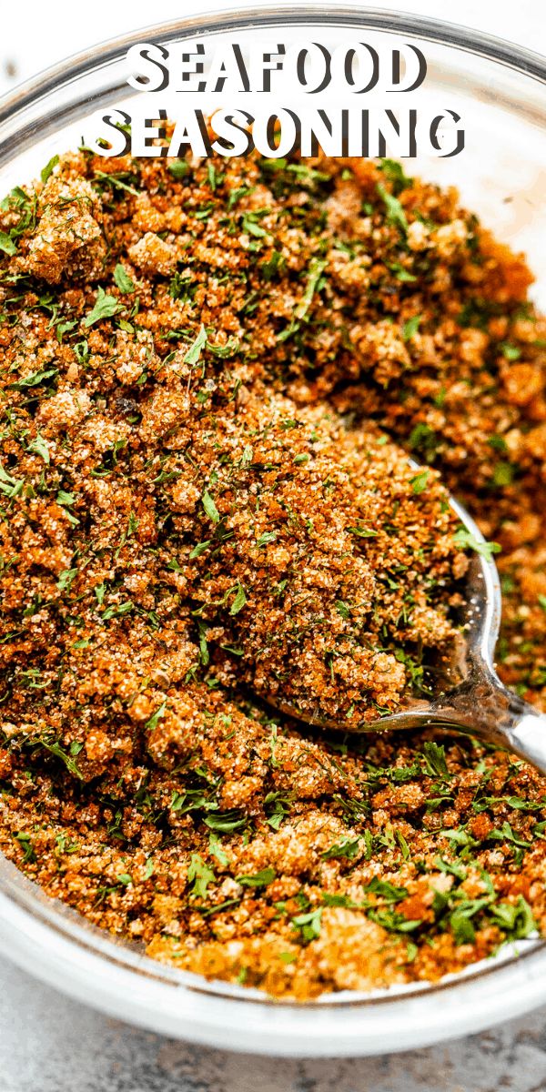 a glass bowl filled with seasoning on top of a table