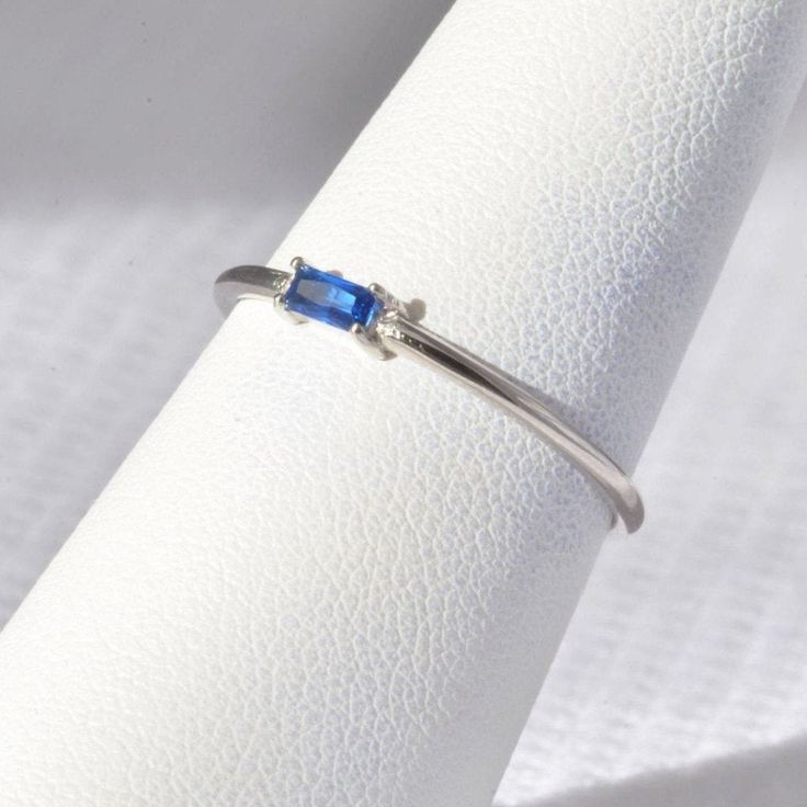 SOLID STERLING SILVER dainty ring with a sapphire-colored (navy blue) rectangular-shaped gemstone. The unique jewelry you can find, a perfect gift for you and your loved one. It's dainty but sturdy and can be worn every day. A special piece you'll truly treasure! High-quality materials and attention to detail. High polished finish. The price is for ONE ring. This dainty, elegant, but sturdy ring comes in a gift box. SIZING INFO: Please be sure you have the correct ring size before making your pu Dainty Stackable Rings With Prong Setting In Sterling Silver, Adjustable Sapphire Ring With Birthstone, Sapphire Crystal Ring Birthstone Fine Jewelry, Minimalist Sapphire Jewelry For Anniversary, Minimalist White Gold Sapphire Promise Ring, Minimalist Silver-colored Birthstone Ring In 14k Gold, Sterling Silver Birthstone Ring Fine Jewelry, Silver Crystal Birthstone Ring In 14k Gold, Minimalist Silver-colored 14k Gold Birthstone Ring