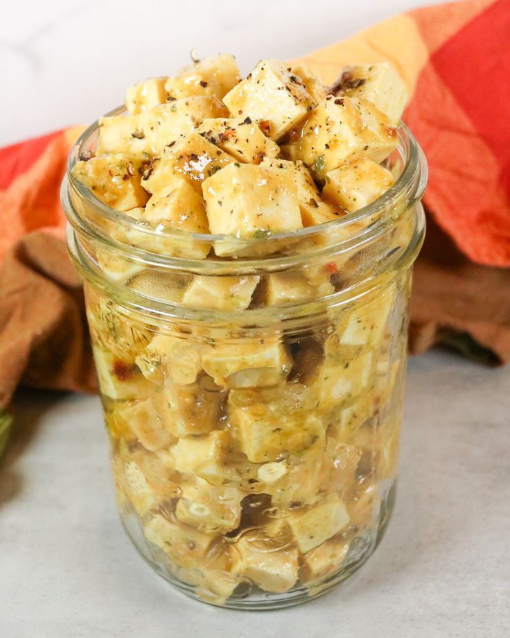 a glass jar filled with food sitting on top of a table