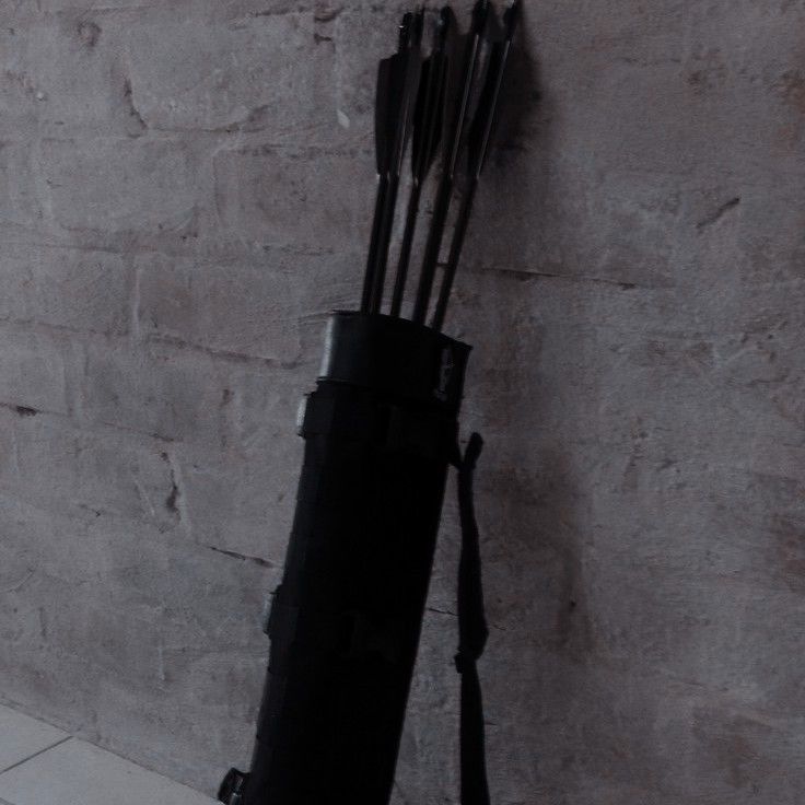 an arrow is leaning against the wall with its bow in it's hand and arrows sticking out from underneath