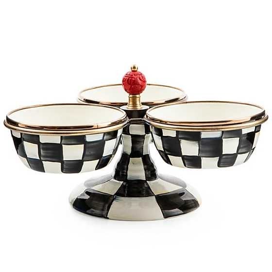 three black and white checkered dishes with a red rose on the top, sitting in front of each other