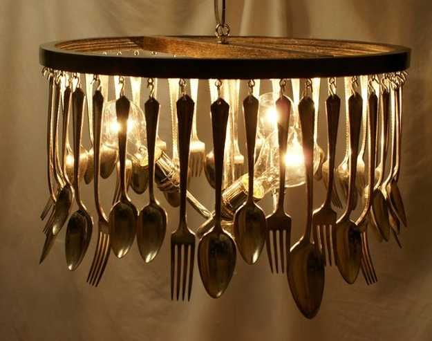 a chandelier with spoons and forks hanging from it