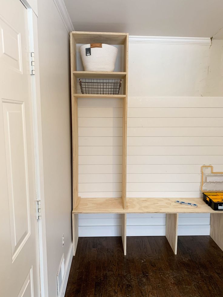 a room with some shelves and a basket on the shelf