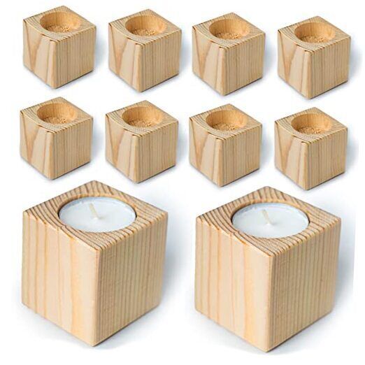 wooden cubes and candles are arranged in the shape of small blocks, each with a candle