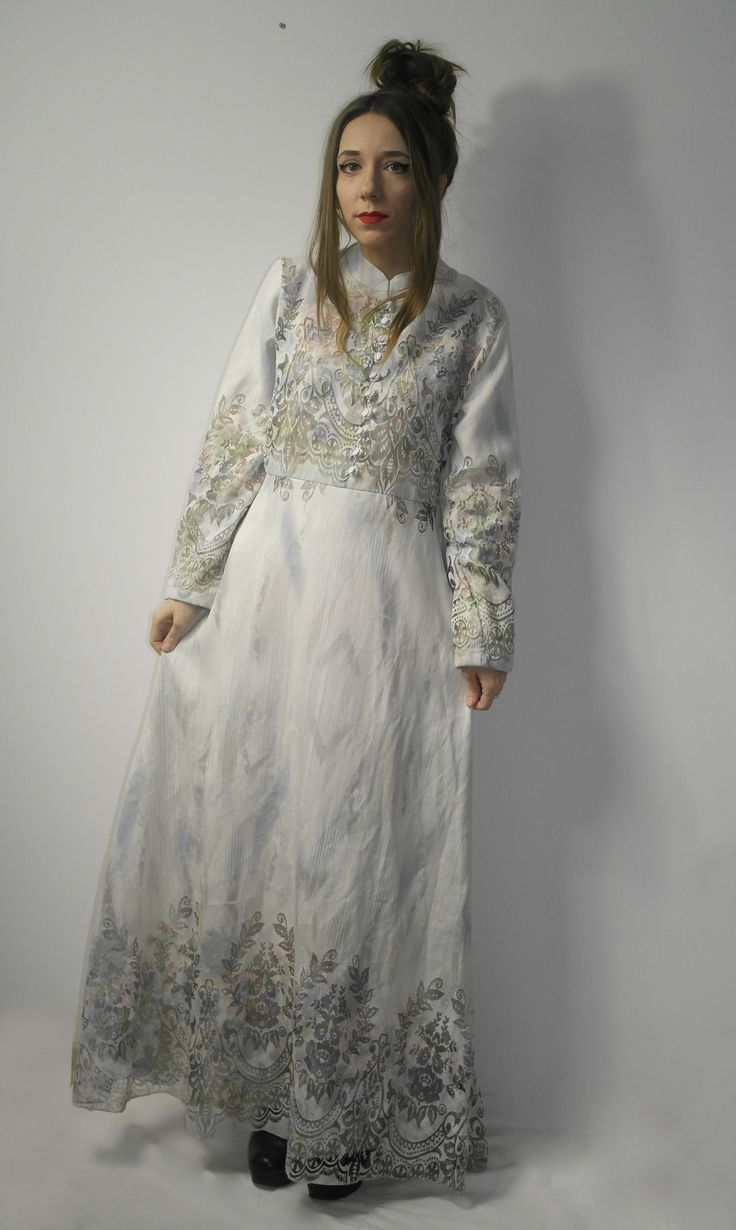 Maxi dress with see through floral patterns. The dress is lined. Brand: Ali Akkaya Size on the label: 44 Measurements, flat: From armpit to armpit: 50 cm (19.68'') The length of the sleeve (measured from armpit): 44 cm (17.32'') Wait: 45 cm x2 (17.72'' x2) Overall length: 144 cm (56.69'') Model in the photos is size 8UK/4US; 164 cm/5'5'' Material: 80% viscose, 20% polyester Very good vintage condition (lightly stained armpit area, light stains in the lining, light damage in the lining)) Due to c Elegant Silk Maxi Dress With Floral Embroidery, Eid Floral Print Long Sleeve Abaya, Elegant Floral Print Maxi Dress For Eid, Formal Spring Maxi Dress With Floral Embroidery, Modest Fitted Dress With Floral Embroidery, Bohemian Maxi Dress For Formal Occasions, Bohemian Style Formal Maxi Dress, Fitted Floral Embroidery Long Sleeve Abaya, Spring Sheer Floor-length Maxi Dress