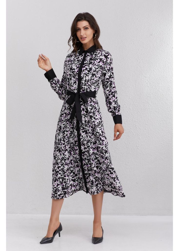 The Twilight Flora Midi Dress combines a striking black and purple floral print with a contrasting black belt for a refined silhouette. Ideal for evening events or a day at the office, this dress effortlessly blends elegance with modesty. Add a touch of sophistication to your fall wardrobe. It extends 49.5 inches from the high point of the shoulder, offering a flattering midi length. A detached self-belt ensures a perfect fit, while detailed cuffs add a touch of class. Fully lined, except for th Skirt Outfits Fall, Day At The Office, Purple Floral Print, Black And Purple, Fall Skirts, Tops Fall, Fall Shopping, High Point, Fall Wardrobe