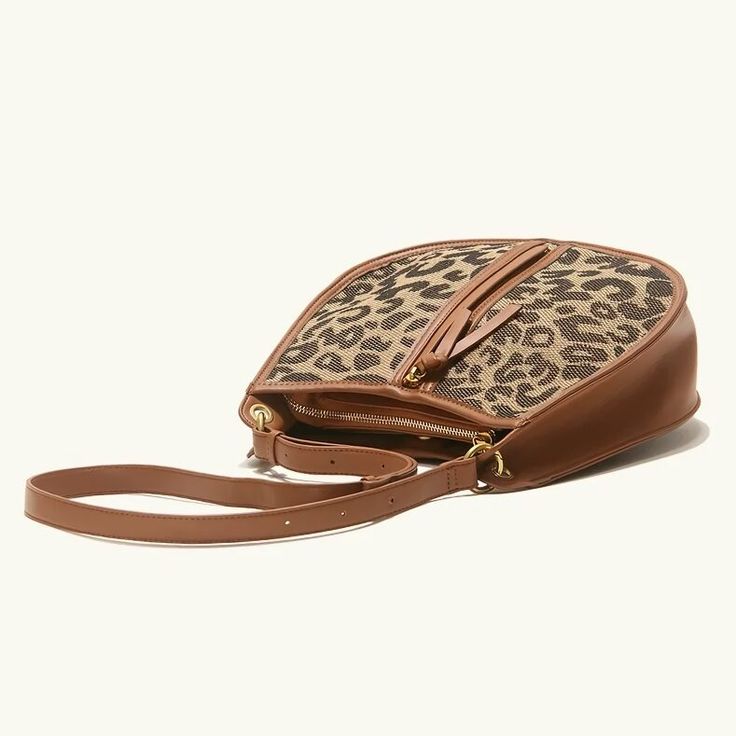 Upgrade Your Style with the Leopard Saddle Shoulder Bag Elevate your fashion game with our Leopard Saddle Shoulder Bag, crafted from premium microfiber leather for a luxurious feel. Designed for the modern woman, this bag combines functionality with trend-setting style, making it the perfect accessory for any occasion. Product Features Microfiber leather upper for durability and a sleek look Polyester lining material for added strength and resilience Zipper closure for secure storage of your essentials Bow decoration adds a touch of charm and femininity Spacious interior with an interior slot pocket for easy organization Available in classic Black or versatile Brown Benefits You'll Love Elevated Style: Stand out from the crowd with the chic leopard print design and sleek saddle shape of th Coated Canvas Saddle Bag With Detachable Strap, Chic Handheld Saddle Bag With Detachable Handle, Trendy Coated Canvas Shoulder Bag With Top Handle, Trendy Coated Canvas Top Handle Shoulder Bag, Coated Canvas Saddle Bag With Adjustable Strap, Trendy Top Handle Shoulder Bag In Coated Canvas, Trendy Leather Bag With Zipper Closure, Trendy Coated Canvas Bag With Detachable Handle, Trendy Bags With Detachable Strap And Coated Canvas