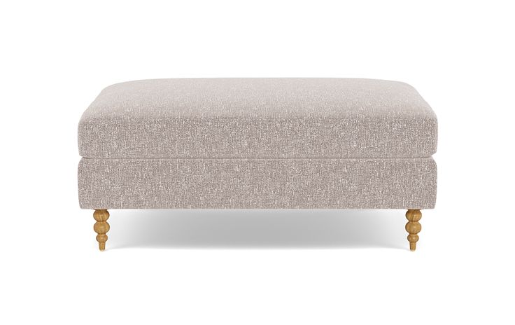 the footstool is upholstered with wooden legs and an upholstered cushion