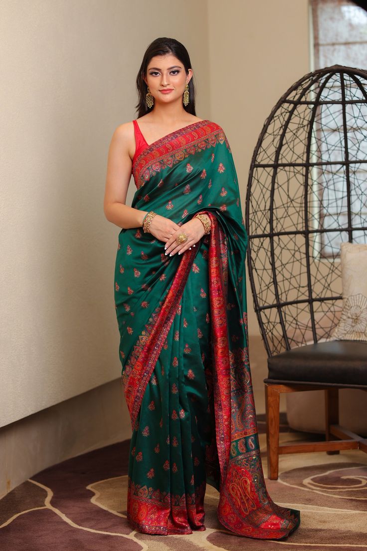 Green Kani saree in silk fabric is accentuated with  Kani weaving  in alluring floral and traditional paisley motifs in beautiful color palette along the borders and pallu. The body of the saree is accentuated with scattered bootis all over. A touch of zari thread adds a hint of shine to enhance the motifs, while contrasting border and pallu add some more color to this stunning saree. It is accompanied with Kani Jamawar blouse piece in contrasting colour. This saree can be a perfect outfit for a Tussar Silk Pre-draped Saree For Traditional Ceremonies, Bollywood Style Jamawar Pre-draped Saree For Puja, Festive Fitted Jamawar Saree, Fitted Jamawar Saree For Navratri, Bollywood Style Jamawar Pre-draped Saree, Green Resham Embroidery Pre-draped Saree For Puja, Green Pre-draped Saree With Resham Embroidery For Puja, Festive Pre-draped Jamawar Saree With Unstitched Blouse, Silk Floor-length Saree For Diwali