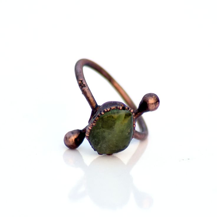 GemFormingStudio D E T A I L S Green Peridot ring | Raw peridot ring | Copper & peridot ring | Electroformed jewelry | Organic stone jewelry | Gemstone Ring, Handmade Ring Ring Size: US : All Sizes Available Gemstone : 11 X 10 MM Weight : 3.00 gm Material : Copper Polish : Copper Antique Polish . Contact us for wholesale prices. R I N G S https://www.etsy.com/in-en/shop/GemFormingStudio?section_id=22783374 B E A D S https://www.etsy.com/in-en/shop/GemFormingStudio?section_id=22828835 W A N D Minimalist Adjustable Green Midi Rings, Earthy Gemstone Rings For Gift, Earthy Gemstone Rings For Gifts, Earthy Gemstone Rings As Gifts, Handmade Adjustable Emerald Promise Ring, Hand Forged Green Jewelry For Promise Ring, Hand Forged Green Ring Jewelry, Hand Forged Green Rings For Gifts, Hand Forged Green Ring