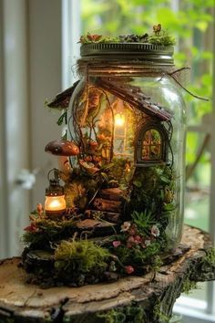 a glass jar filled with moss and lit candles