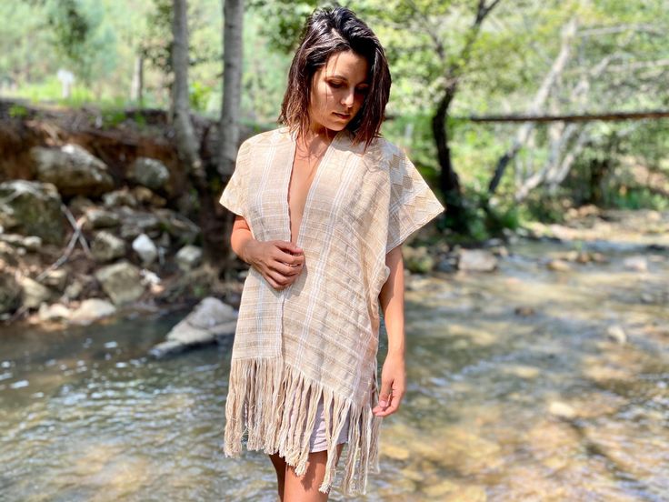 A true Masterpiece  Relaxed flowy fit, open-front design. Our Hand-loomed bohemian poncho Top,is a unique and stylish garment. Featuring hand embroidered geometric designs, It is made with a traditional Mayan waist loom. Each thread is patiently passed through by hand using a number of techniques with wooden needles to create movement in the two tone designs. created by Mayan women and drum and dress,in the beautiful mountains of Mexico.  ~SIZES~   SX-S   M-L ~MATERIAL~ 100% cotton ~CARE~ Hand w Mayan Women, Poncho Top, Poncho Tops, Cropped Tube Top, Boho Top, Beautiful Mountains, Hand Loom, Geometric Designs, Boho Tops