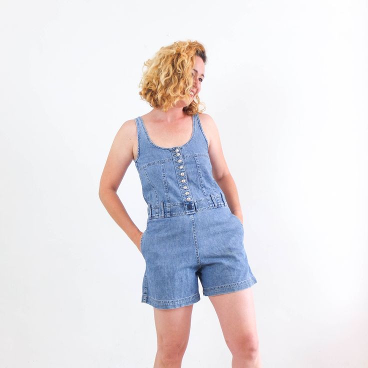 Amazing vintage 90's blue denim romper for womne. This vintage denim romper jumpsuit with shorts has button up, pockets and belt loops. The vintage denim playsuit romper is cotton fabric in excellent vintage conditions by Onyx. The size of this romper is Small, the chest contour fit is 31,4 inch. (80 cm) ** MEASURES FLAT ** Armpit to armpit 15,7 in // 40 cm Waist 16,5 in // 42 cm Hip 20 in // 51 cm Inner leg 4,3 in // 11 cm Front rise 11,4 in // 29 cm Length from shoulder 31,4 in // 80 cm Length Summer Cotton Shortalls With Relaxed Fit, Summer Overalls With Relaxed Fit, Summer Cotton Shortalls Overall, Summer Relaxed Fit Bib Front Shortalls, Summer Shortalls With Pockets In Relaxed Fit, Relaxed Fit Summer Shortalls With Pockets, Summer Relaxed Fit Shortalls With Pockets, Summer Style Relaxed Fit Shortalls With Pockets, Summer Light Wash Shortalls