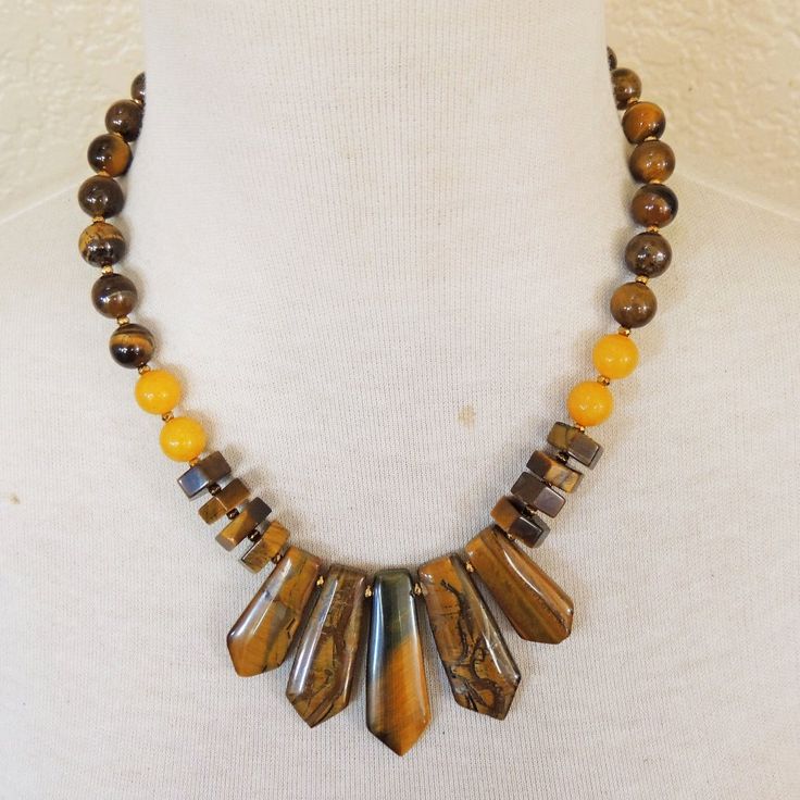 - New & Handmade Materials: Tiger's Eye, Golden Jade, Goallic Spacer Beads, Gold Plated Lobster Clasp And Extender Chain - Length: Necklace: 18 3/8" From End To End, 2" Extender Chain - Longest Pendant Point: 1 3/4" L X 3/4" Boho Necklace Autumn Necklace Artisan Yellow Gemstone Bead Necklaces, Artisan Yellow Gemstone Beaded Necklaces, Yellow Artisan Beaded Necklace With Adjustable Fit, Artisan Yellow Gemstone Beads Necklace, Lucky Brand Necklace, Paper Beads Necklace, Fan Jewelry, Autumn Necklace, Long Pearl Necklaces