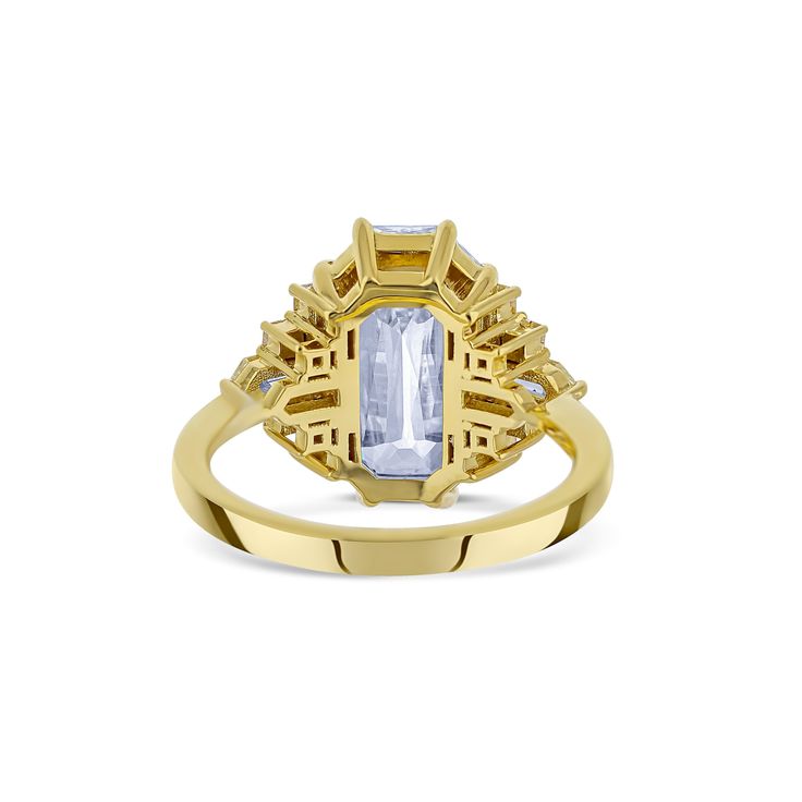 a yellow gold ring with an aqua blue topazte surrounded by white diamond accents