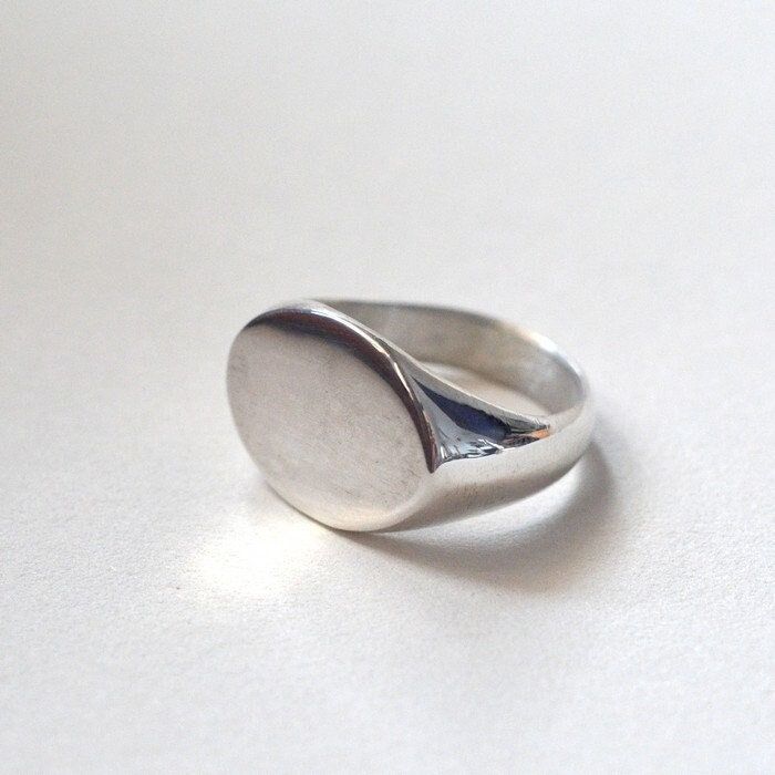 Tabula Rasa. Start your story. A moment of silence before writing, before characters enter, a path is laid. A blank page. The beginning and its freshness. . Kept in the spirit of minimalism and simplicity, a silver signet ring with a streamlined shape and an oval front. The piece is handmade in wax and then cast in sterling silver, hand-finished. . Comfortable. Visible. Ladies'. Men's. Unisex. . The signet ring is polished. Weight of the ring: 10 - 11 g. Size: please choose from the table of ava Everyday Sterling Silver Signet Ring, Minimalist Rounded Signet Ring As Gift, Minimalist Rounded Signet Ring For Gift, Oval Sterling Silver Dome Ring For Everyday Wear, Everyday Polished Signet Ring, Everyday Polished Finish Signet Ring, Minimalist Oval Sterling Silver Engraved Ring, Sterling Silver Polished Signet Ring, Sterling Silver Signet Ring With Polished Finish