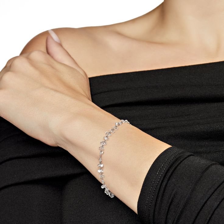 Discover the elegance of our Dancing Diamond Bracelet, a handcrafted masterpiece featuring laser-drilled round rose-cut diamonds. Its refined design ensures it seamlessly integrates into your everyday wardrobe. This versatile piece pairs beautifully with any outfit and is especially stunning when matched with our Rose-Cut Diamond necklaces for a coordinated look. Details 18K White Gold, 1.46 Grams5.25 Carats of Diamonds Elegant Sterling Silver Bracelet With Round Cut, Elegant Diamond Bracelet With Single Cut Diamonds For Party, Elegant Diamond Accented Bracelets For Parties, Elegant Diamond Accented Tennis Bracelet For Party, Timeless Sterling Silver Diamond Bracelet For Wedding, Elegant Party Tennis Bracelet With Diamond Accents, Elegant Party Bracelets With Diamond Accents, Party Diamond Tennis Bracelet, Elegant Silver Tennis Bracelet With Diamond Cut