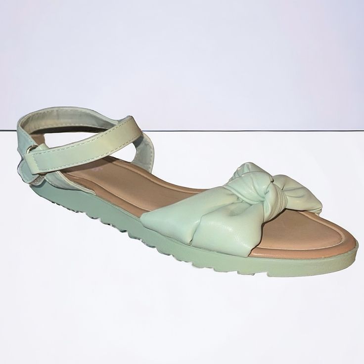 New. Never Worn. Add A Delightful Twist To Her Style With These Mint Green Faux Leather Sandals Featuring Charming Knot Straps And Easy-On Off Velcro And Loop Closures For A Touch Of Sweetness In Every Step. Material: Faux Leather- Polyurethane Instructions: Spot Clean Cute Green Open Toe Sandals, Open Toe Synthetic Sandals With Soft Sole, Synthetic Open Toe Sandals With Soft Sole, Green Adjustable Sandals With Round Toe, Adjustable Green Sandals With Round Toe, Spring Sandals With Soft Sole In Synthetic Material, Comfortable Sandals With Soft Sole For Spring, Spring Sandals With Soft Synthetic Sole, Cute Ankle Strap Synthetic Sandals